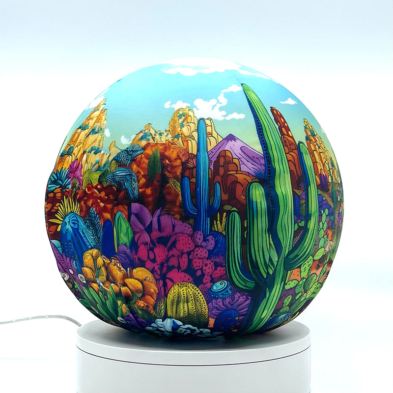 Fabric sphere cover with a colorful cactus doodle design, wrapped around a 8.7" soccer ball, 9.5" basketball ball, or a 10" globe.