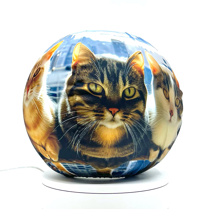 Fabric sphere cover featuring six cats atop a skyscraper design, wrapped around a 8.7" soccer ball, 9.5" basketball ball, or a 10" globe.