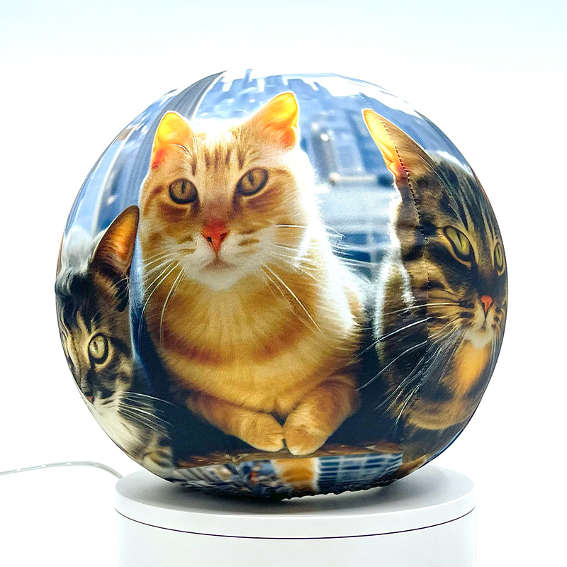 Fabric sphere cover featuring six cats atop a skyscraper design, wrapped around a 8.7" soccer ball, 9.5" basketball ball, or a 10" globe.