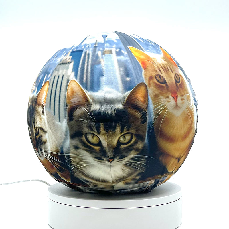 Fabric sphere cover featuring six cats atop a skyscraper design, wrapped around a 8.7" soccer ball, 9.5" basketball ball, or a 10" globe.