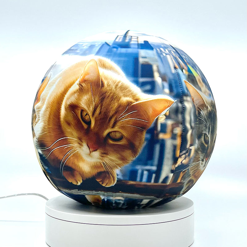 Fabric sphere cover featuring six cats atop a skyscraper design, wrapped around a 8.7" soccer ball, 9.5" basketball ball, or a 10" globe.