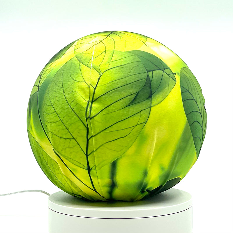 Fabric sphere cover with a close-up bright translucent leaf design, wrapped around a 8.7" soccer ball, 9.5" basketball ball, or a 10" globe.