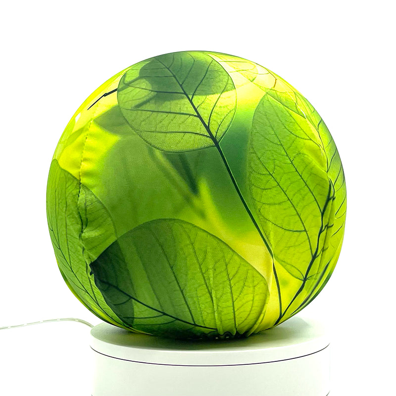 Fabric sphere cover with a close-up bright translucent leaf design, wrapped around a 8.7" soccer ball, 9.5" basketball ball, or a 10" globe.