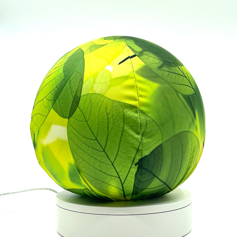 Fabric sphere cover with a close-up bright translucent leaf design, wrapped around a 8.7" soccer ball, 9.5" basketball ball, or a 10" globe.