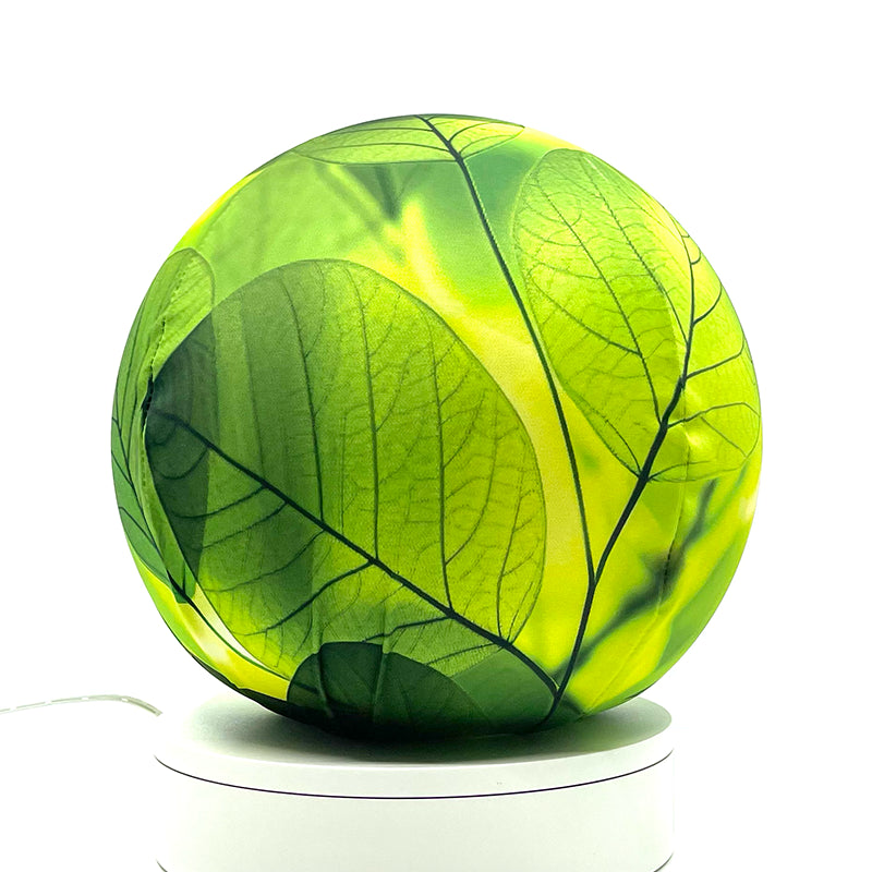 Fabric sphere cover with a close-up bright translucent leaf design, wrapped around a 8.7" soccer ball, 9.5" basketball ball, or a 10" globe.