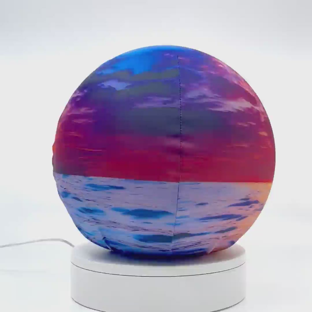 360°-rotating fabric sphere cover featuring an ocean sunset design, wrapped around a 8.7" soccer ball, 9.5" basketball ball, or a 10" globe.